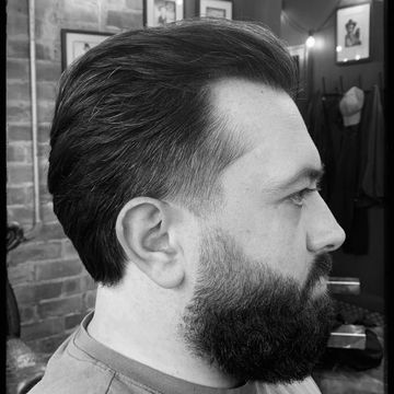 A finished haircut and shaped full beard at Crooked Crown