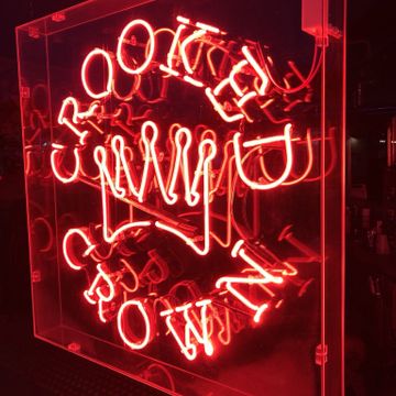 Our real Crooked Crown neon sign glowing in the shop